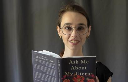 Photo by Karen Olson. Photo of Author Abby Norman with her book Ask Me About My Uterus.