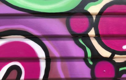 A small slice of the vibrant purple, yellow, green and blue shapes that make up the mural