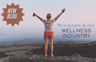 Woman with arms outstretched standing on top of a large hill